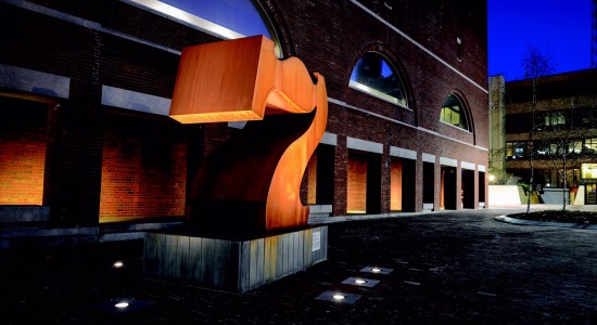 Number seven sculpture by Corey next to brick building